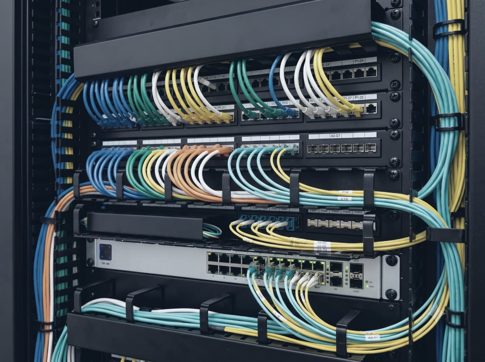 Neatly combed and labeled patch-panel cabling after the refresh