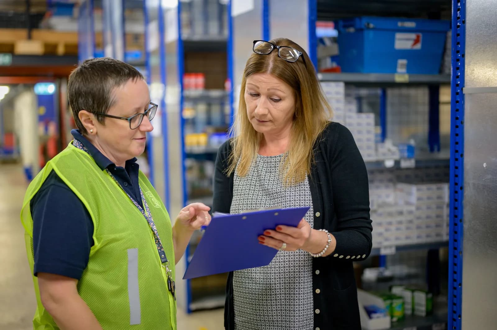 Quality auditor reviewing supplier evidence in a manufacturing setting